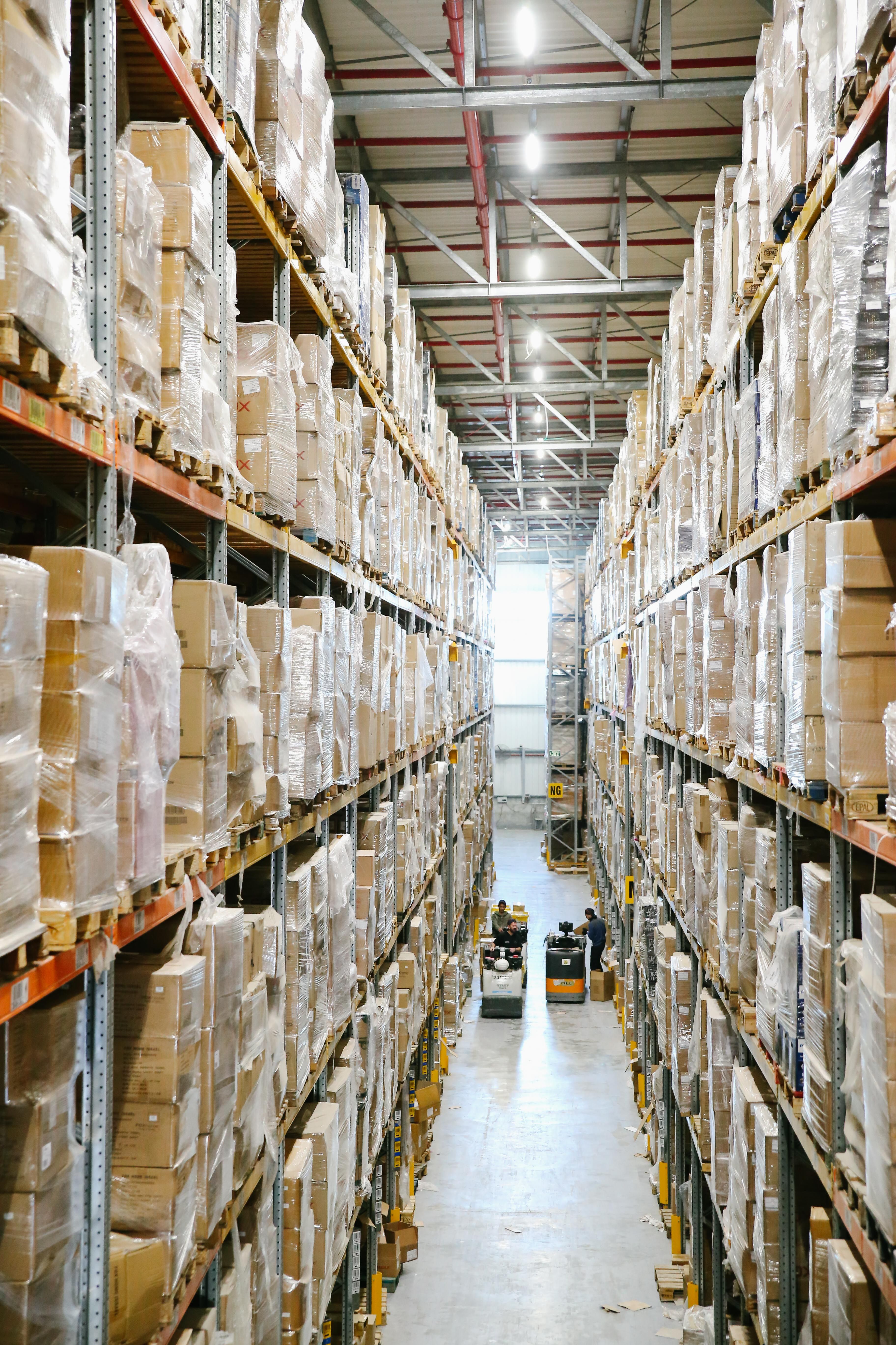 A wide aisle inside a working warehouse