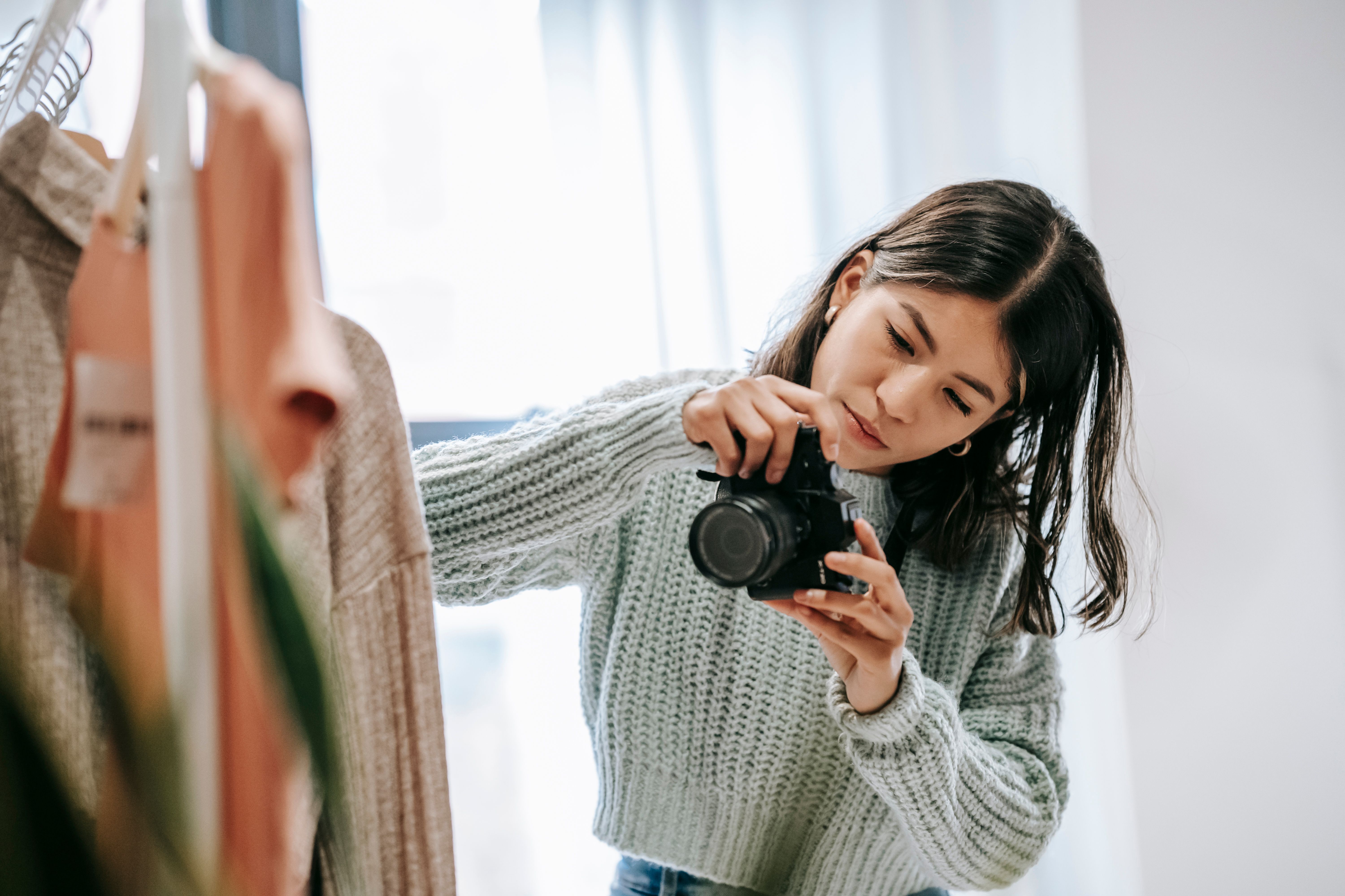 A photographer capturing fashion products in a studio