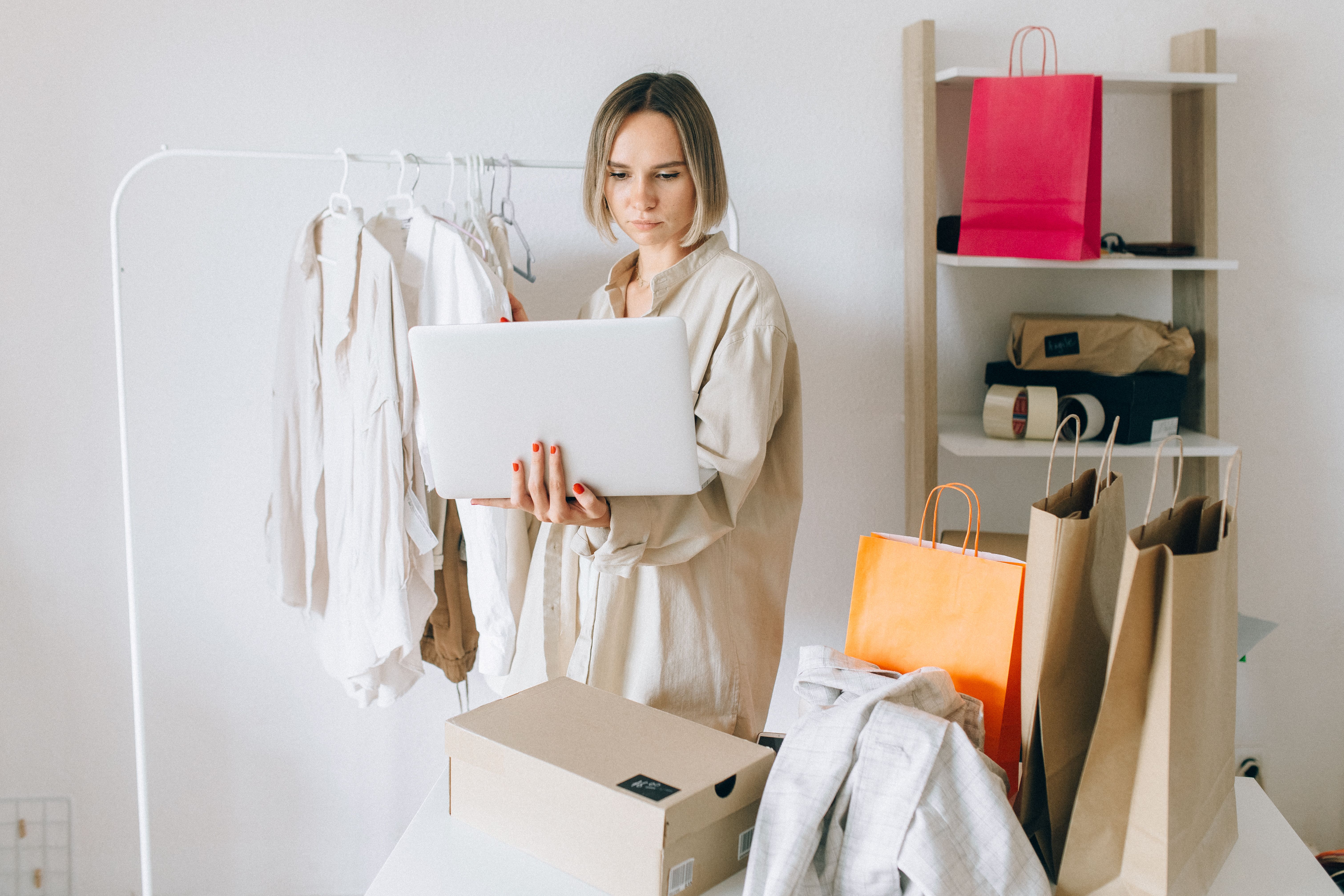 Fashion ecommerce work coordinated beside products and packed orders